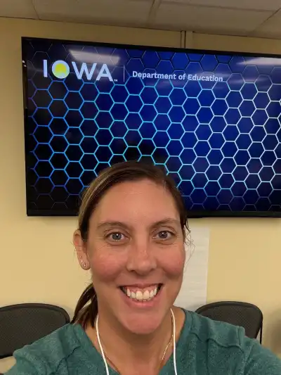 Image of woman in front of sign